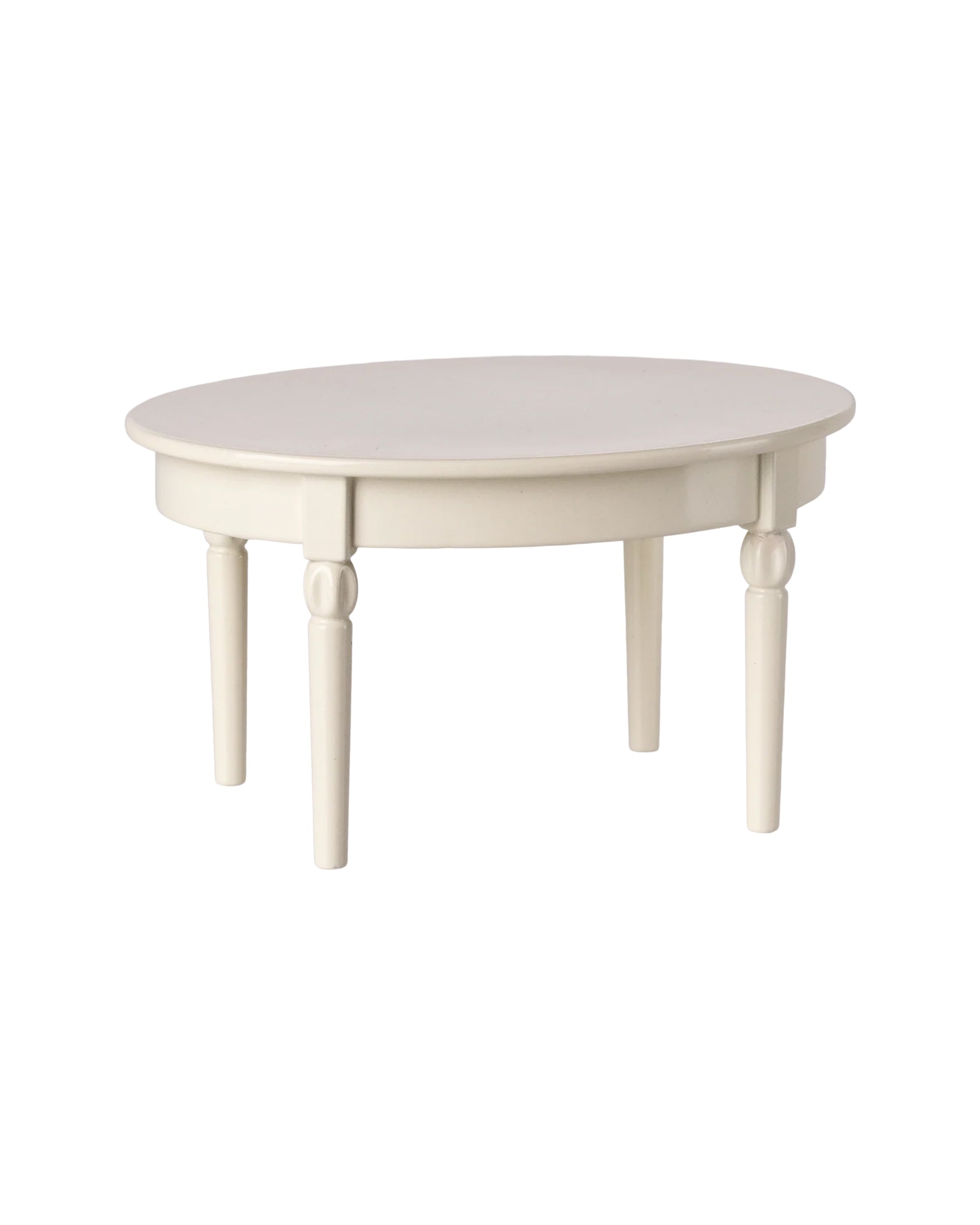 The Maileg Vintage Dining Table by Maileg is a white, round wooden table with four tapered legs, offering an exclusive look and shown against a plain white background.