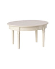 The Maileg Vintage Dining Table by Maileg is a white, round wooden table with four tapered legs, offering an exclusive look and shown against a plain white background.