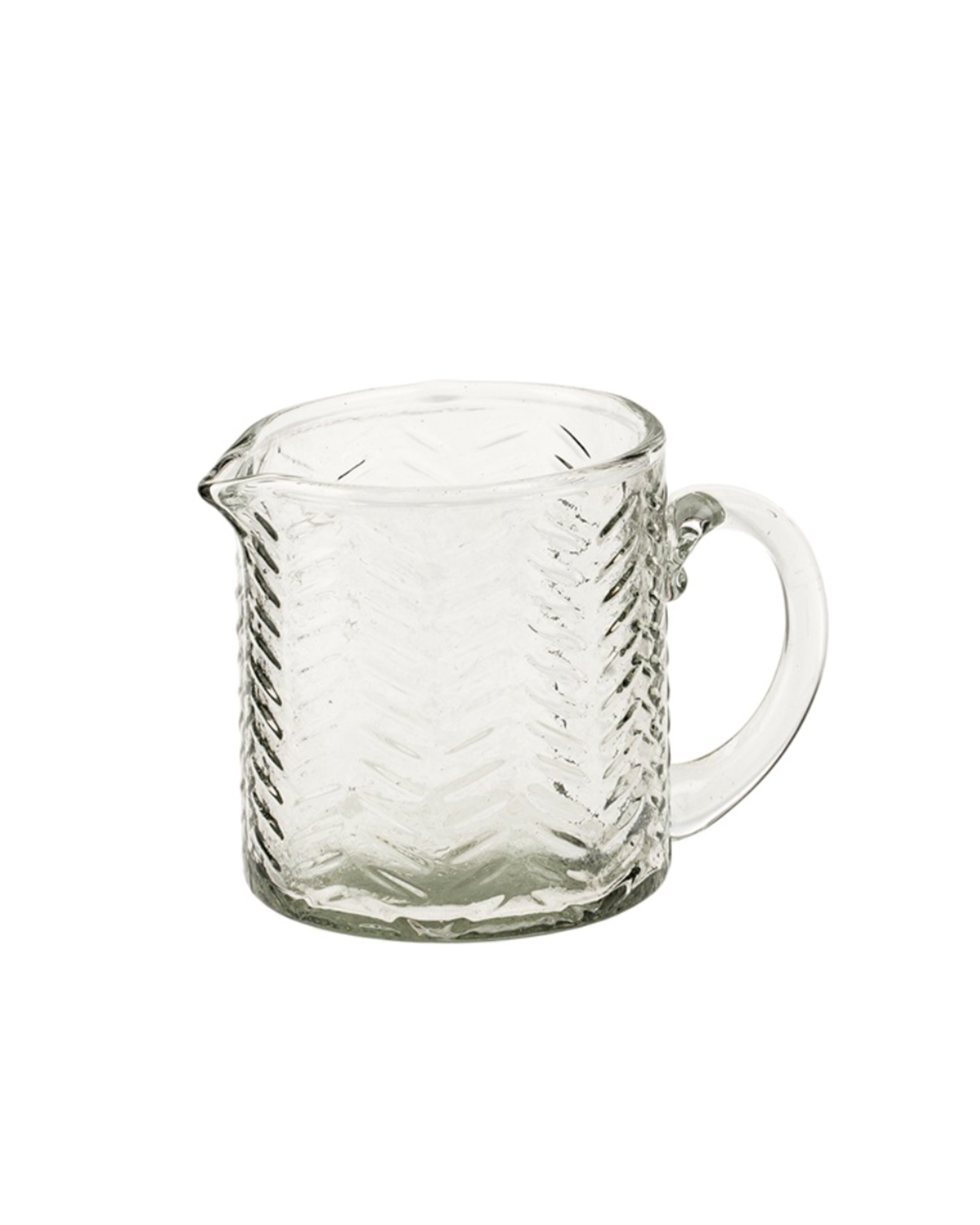 The Indaba 4-7025 Malibu Petit Pitcher is an artisan-crafted clear glass jug with a handle, spout, and herringbone pattern, shown against a plain white background.