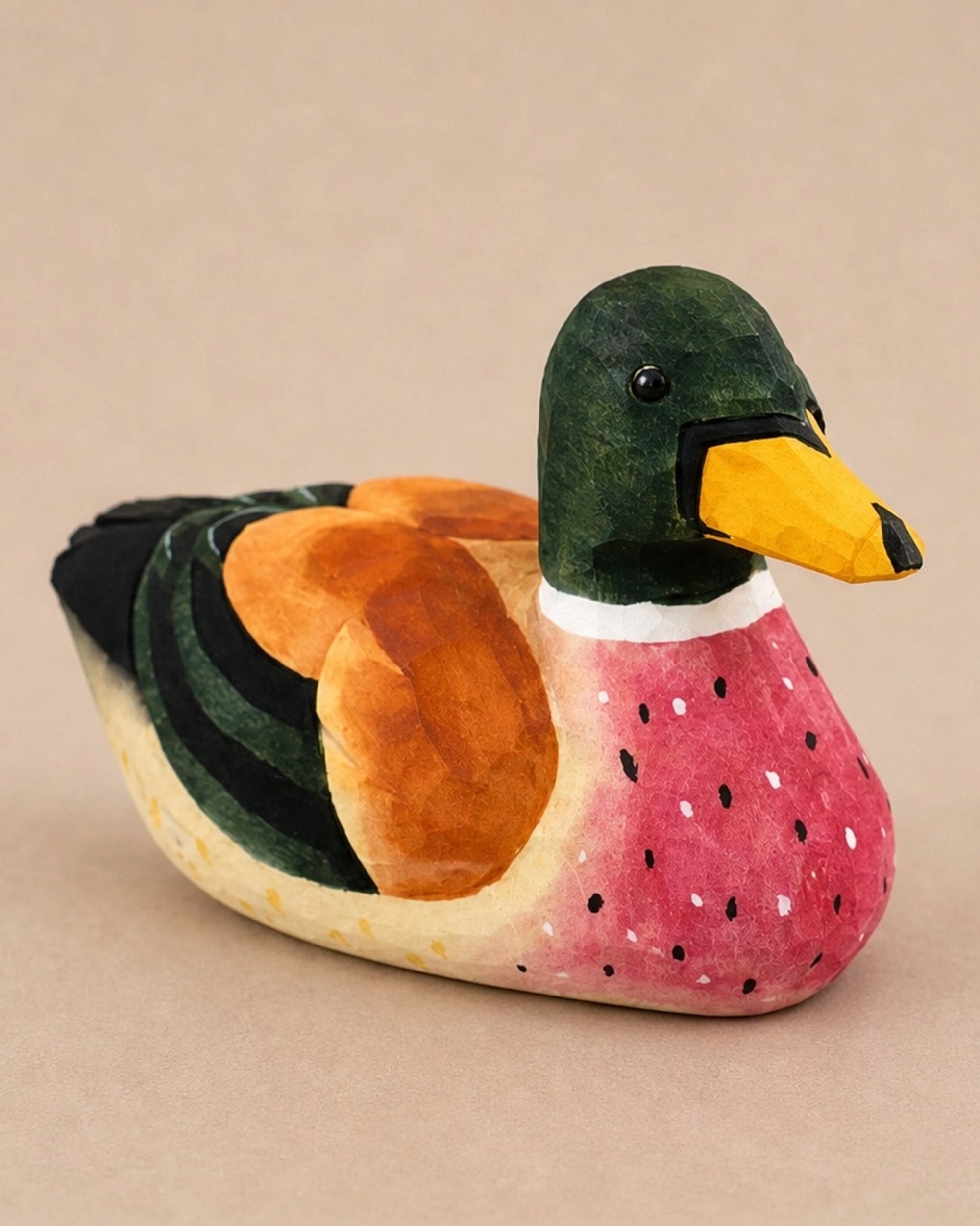 Green hand-painted carved basswood duck with yellow beak, rustic decor by Faire for Bungalow Furniture &amp; Accessories.