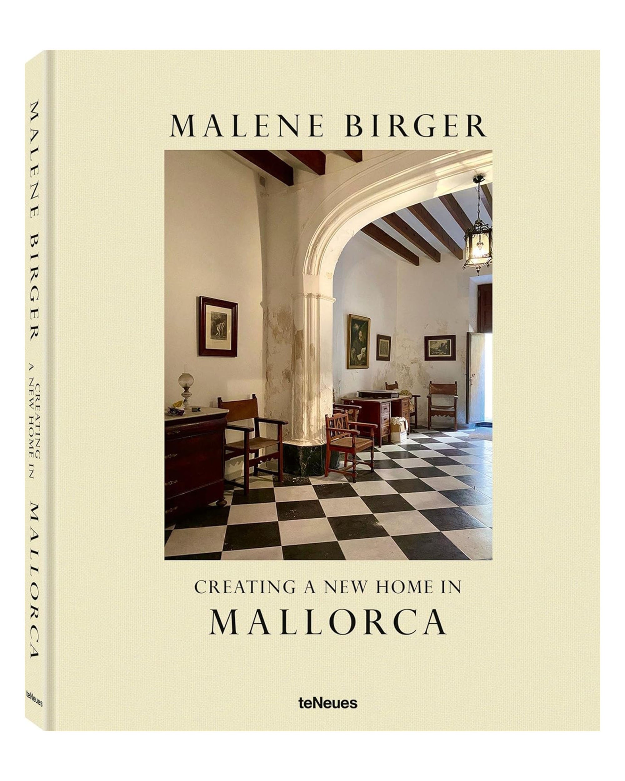 Book cover of "Creating A New Home In Mallorca" by Ingram Book Company features a Mallorca renovation with an elegant interior—black-and-white checkered floor, classic furniture, artwork, and arched ceilings.
