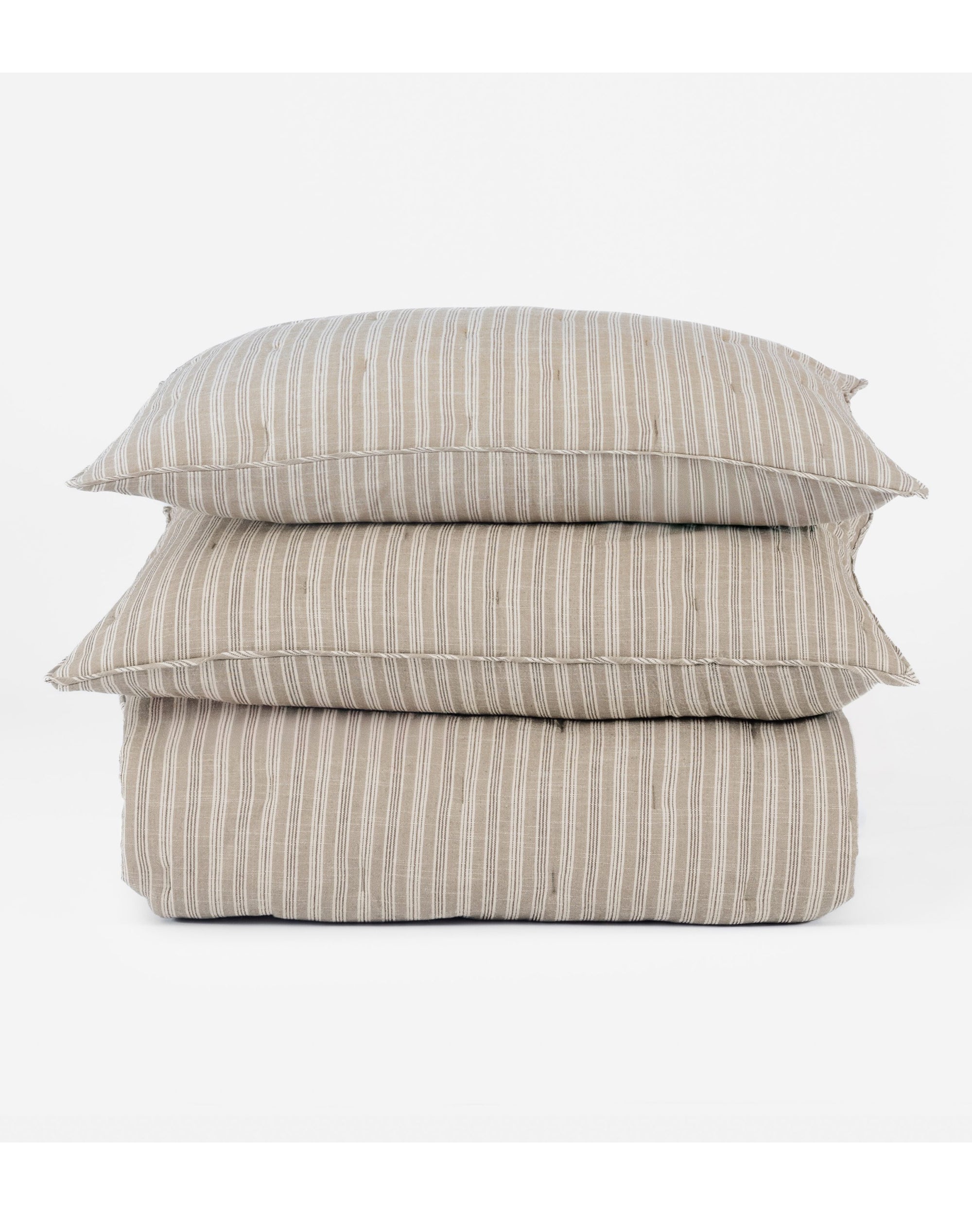 Two beige Mallory Quilt Oversized King pieces by Amity Home, made of 100% cotton with a subtle ticking stripe pattern, are neatly stacked against a plain white background.