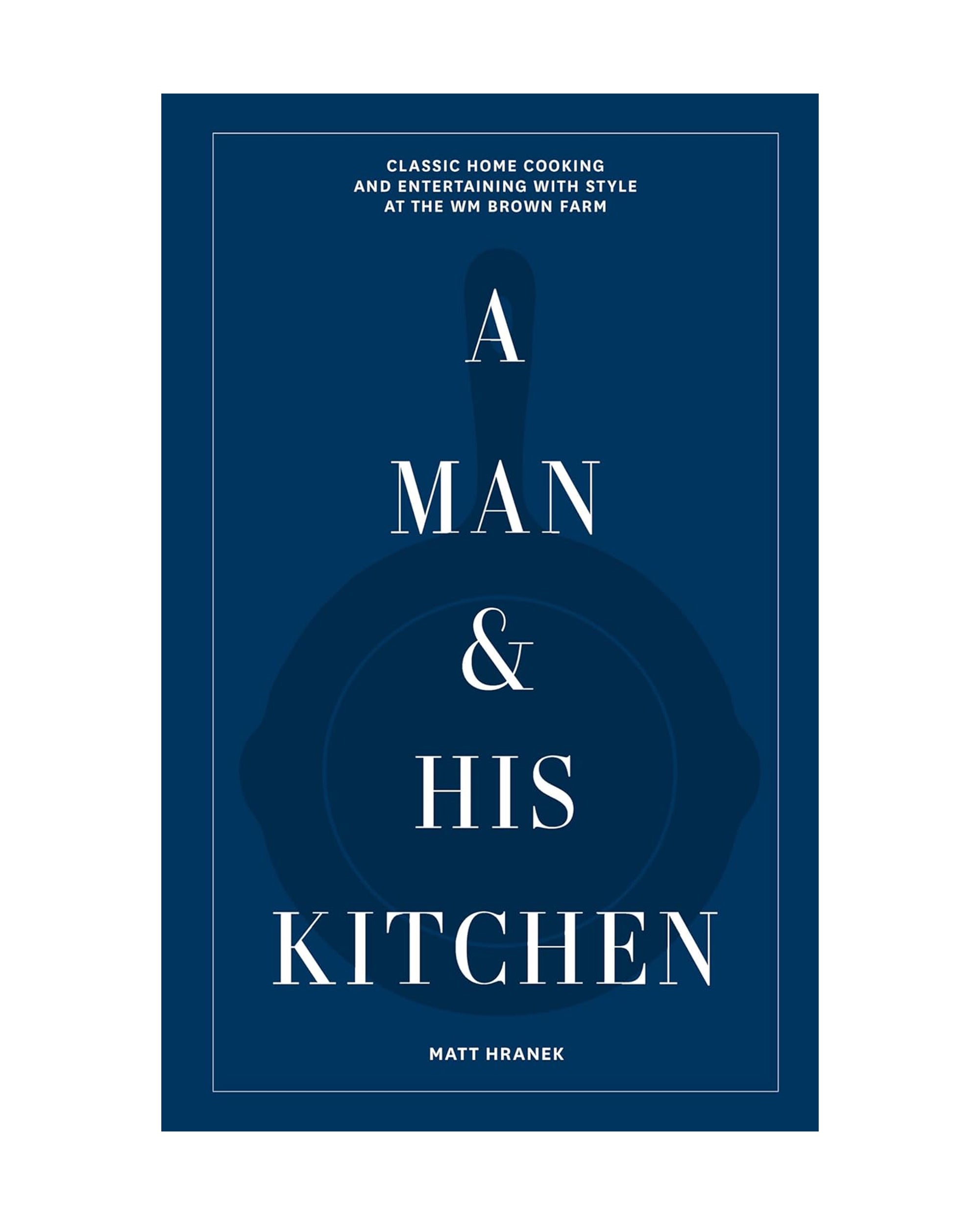 This Hachette Book Group cookbook, "A Man & His Kitchen," features a dark blue cover with white text and a subtle skillet outline. Author Matt Hranek offers simple recipes for men, highlighted above and below the bold title.