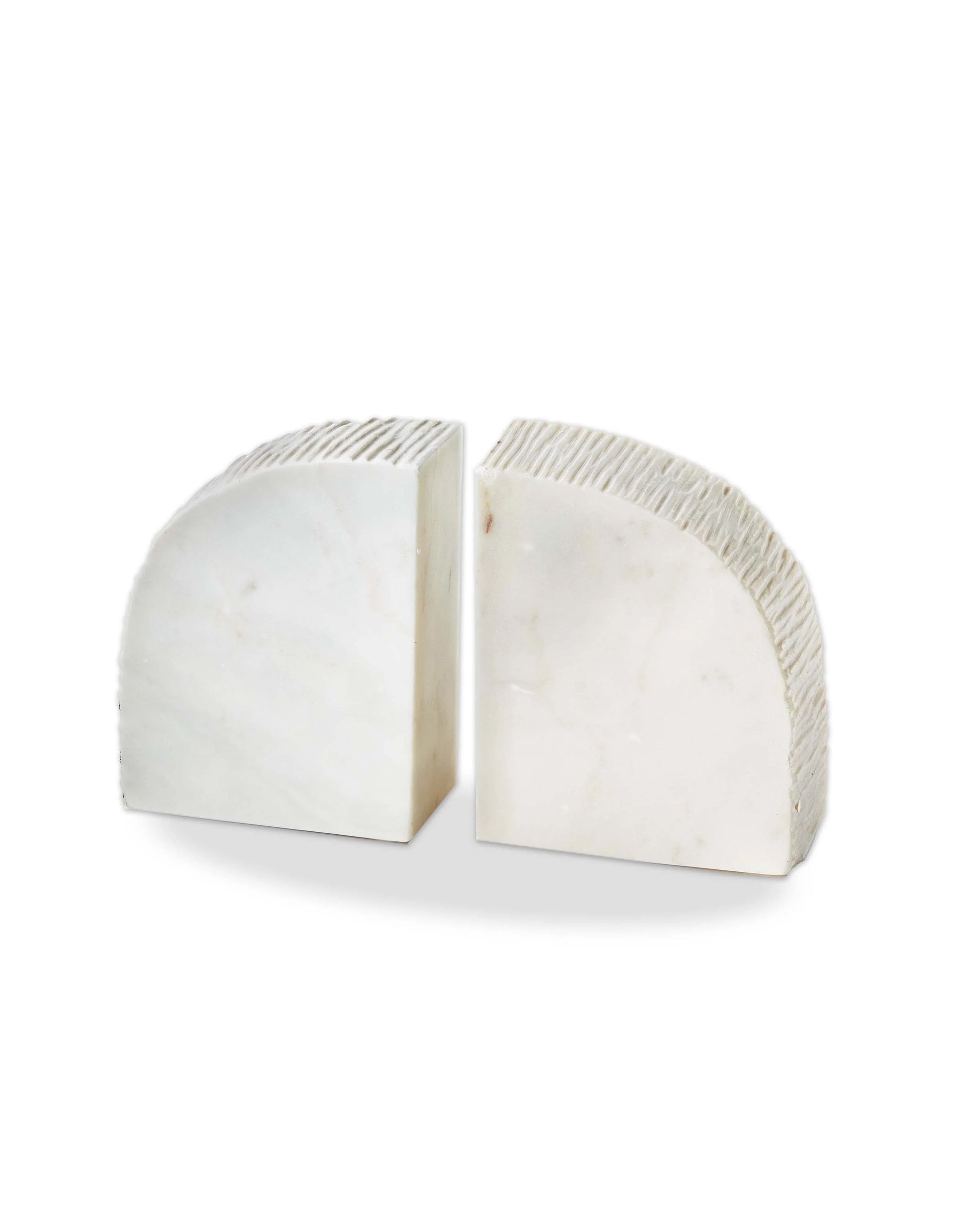 The Tag Arch Marble Bookends feature white marble with subtle gray veining, a ridged texture on one semi-circular side, and smooth surfaces elsewhere, perfect for stylish bookshelf décor or decorative bookends.