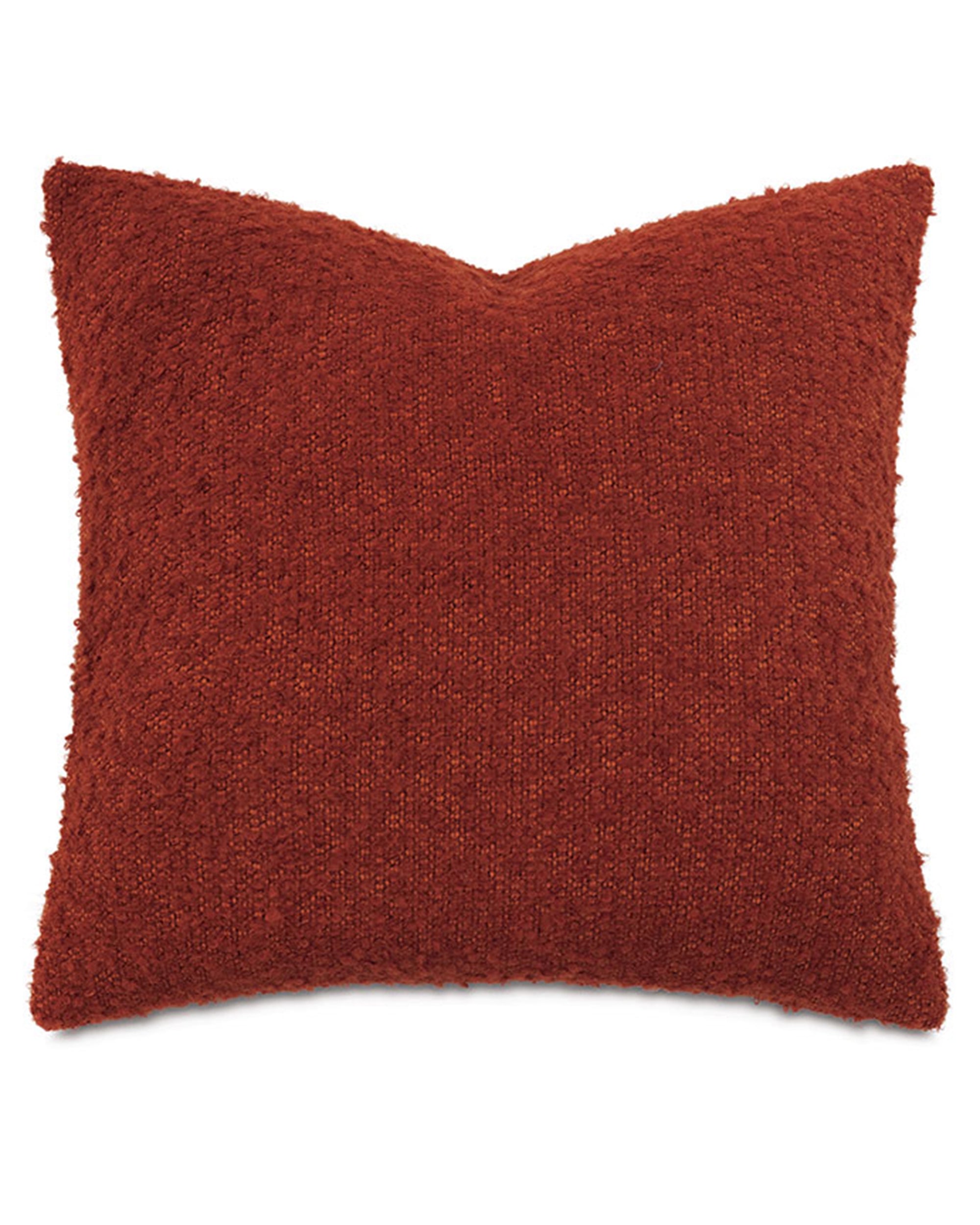 Rust-colored square pillow with boucle texture, indented top corners, by Eastern Accents, MARL Brick collection.