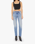 A person in a black cropped tank top, Mother Mid Rise Hiker Hover light blue stretch denim slim straight-leg jeans, and pointed black ankle boots stands against a plain white background.