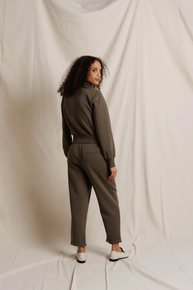 Milana Track Jacket by Perfectwhitetee in cream, shown on model looking over her shoulder against a neutral backdrop.