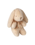 The Maileg Plush Bunny /Mini by Maileg is a soft stuffed bunny with floppy ears, black stitched eyes, and a brown twine bow around its neck, sitting upright against a white background.