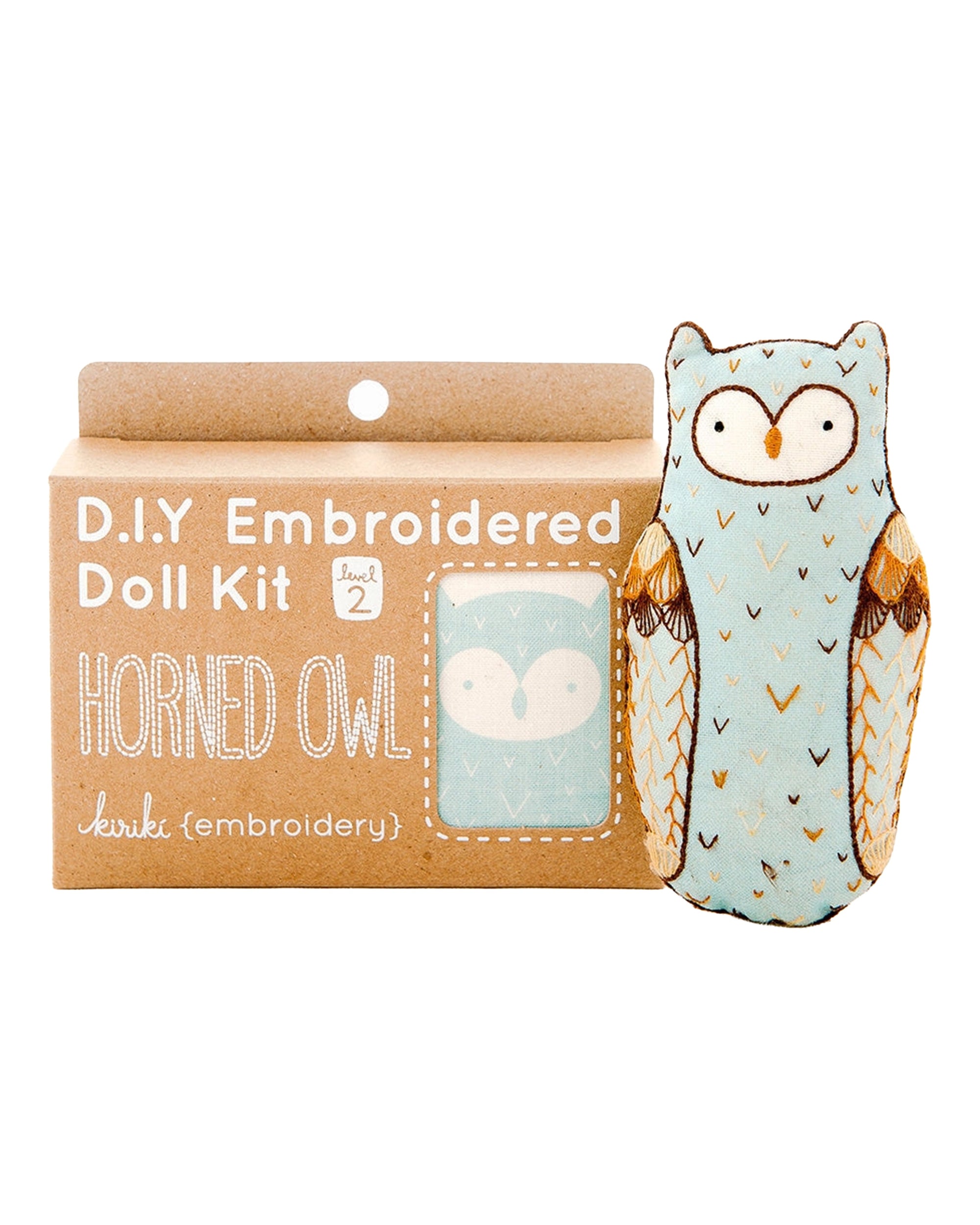 The Faire Horned Owl Embroidery Kit is a DIY set for making a plush with a light blue horned owl design, packaged in a box featuring an illustrated owl and “level 2” embroidery instructions using the charming Horned Owl Pattern.