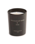 A luxury scented mini candle (2.4 OZ) from European Scents LLC, featuring "Bulgarian Rose & Oud" in a black jar with white wax and elegant white labeling.