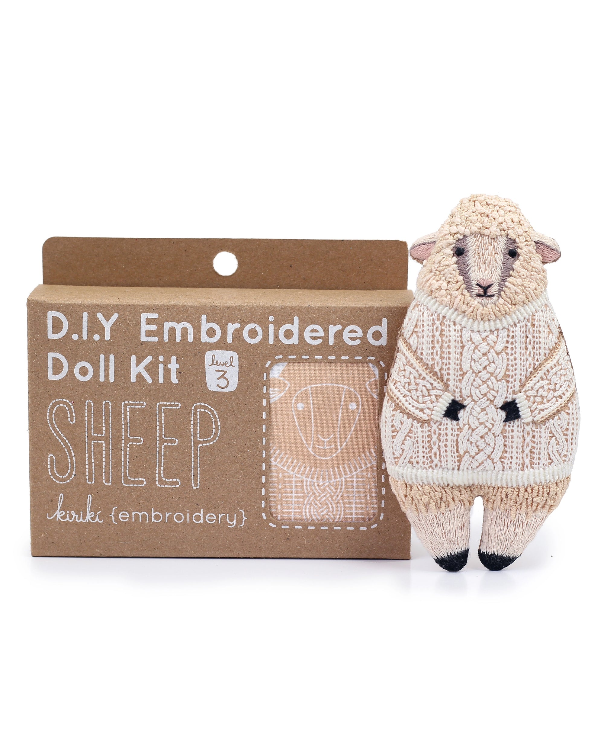 Faire Sheep Embroidery Kit: DIY set to create a plush sheep in a detailed, knitted-style sweater. Comes in a box with an illustrated sheep design and includes a level 3 sheep embroidery pattern for creative fun.