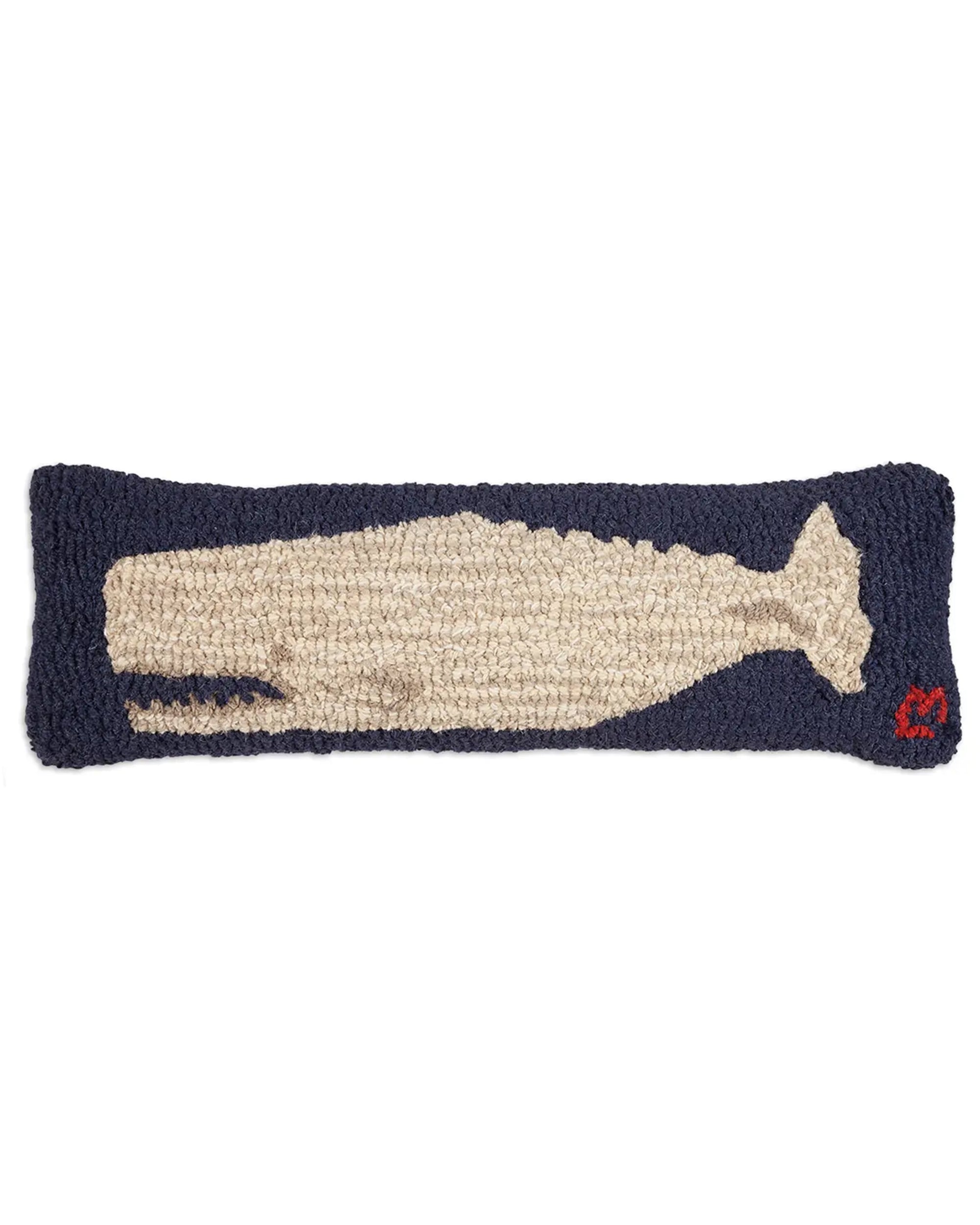 The C4C Moby Dick Whale Pillow by Faire is a rectangular, navy blue hand-hooked wool pillow featuring a beige whale in the center and a small red heart stitched in the lower right corner.