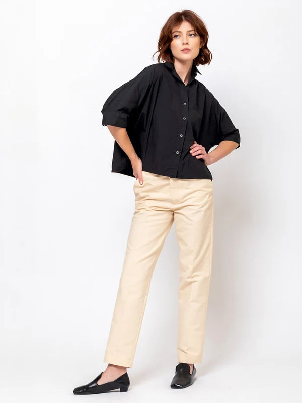 Black Daria Shirt by Monday12 styled with beige pants, modern look against a white background.
