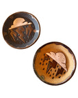 The Faire Monsoon Trinket Dish set includes two round ceramic dishes—one in dark, one in light earthy tones—each with a cloud, lightning bolts, and raindrops. Ideal as monsoon-inspired gifts or handmade desert décor.