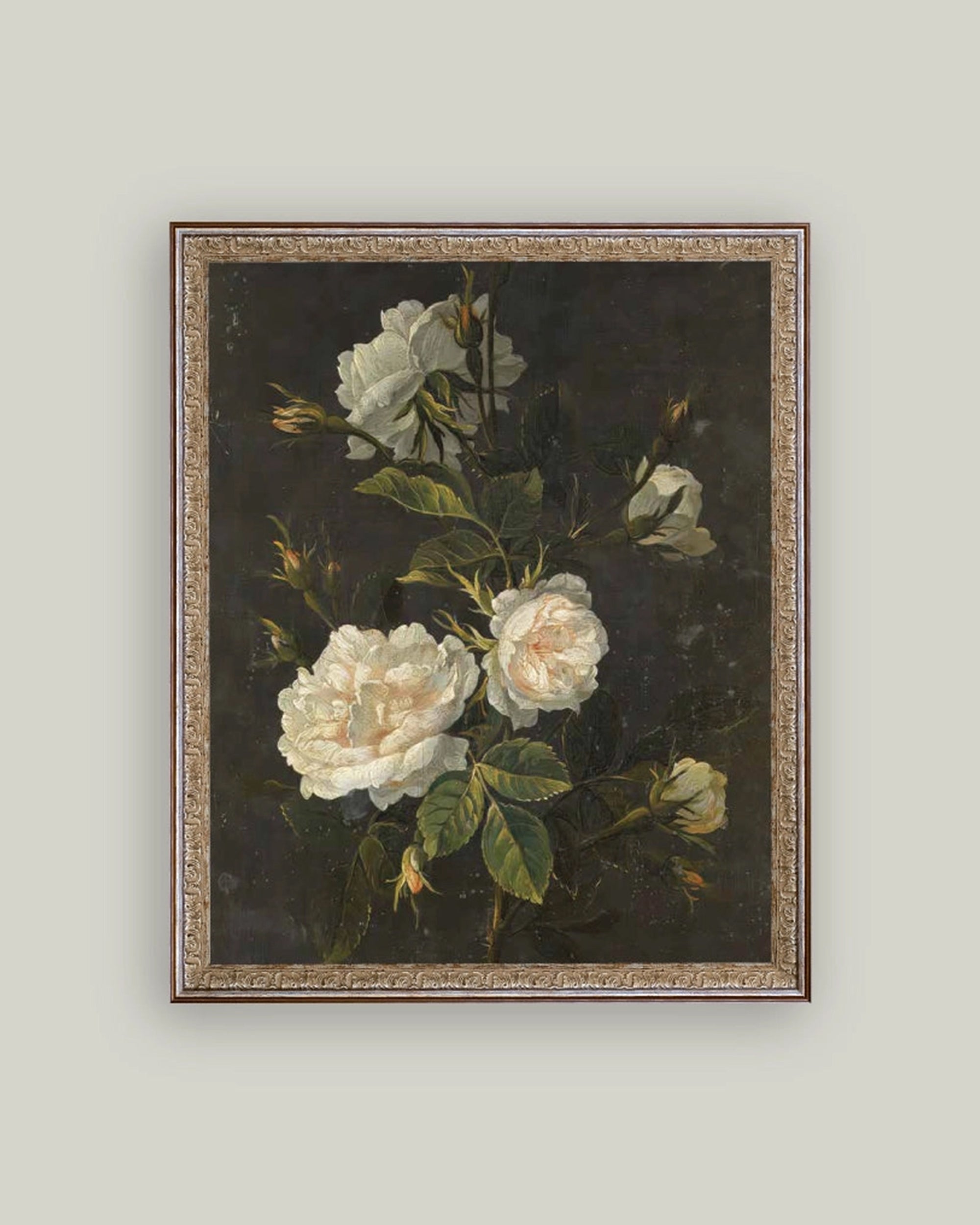Still Life with Rose Framed Art by Petal Lane Home features white roses with green leaves on a dark background, displayed in a handcrafted ornate frame with a gold decorative border. Perfect for accenting any light-colored wall.