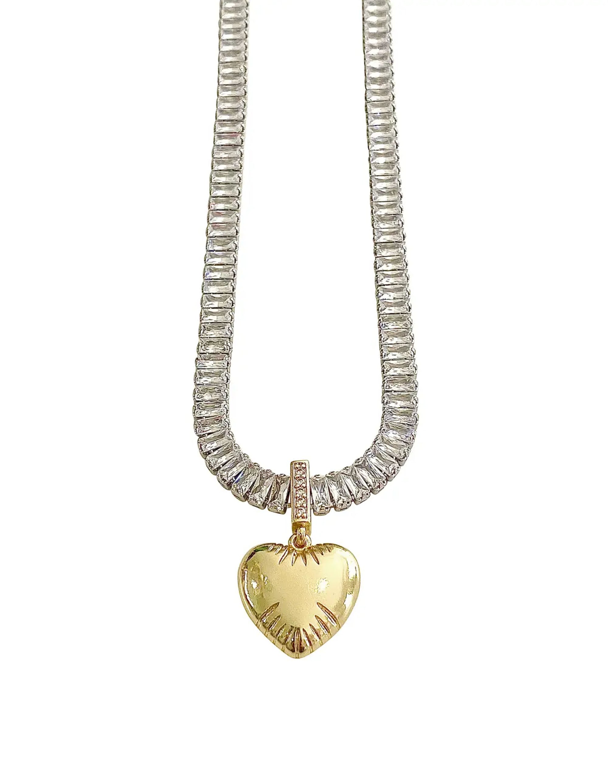 The Myra Heart Necklace by Faire is a silver chain with an 18k gold-plated, heart-shaped pendant featuring a textured edge and a small rectangular bail accented with CZ detail.