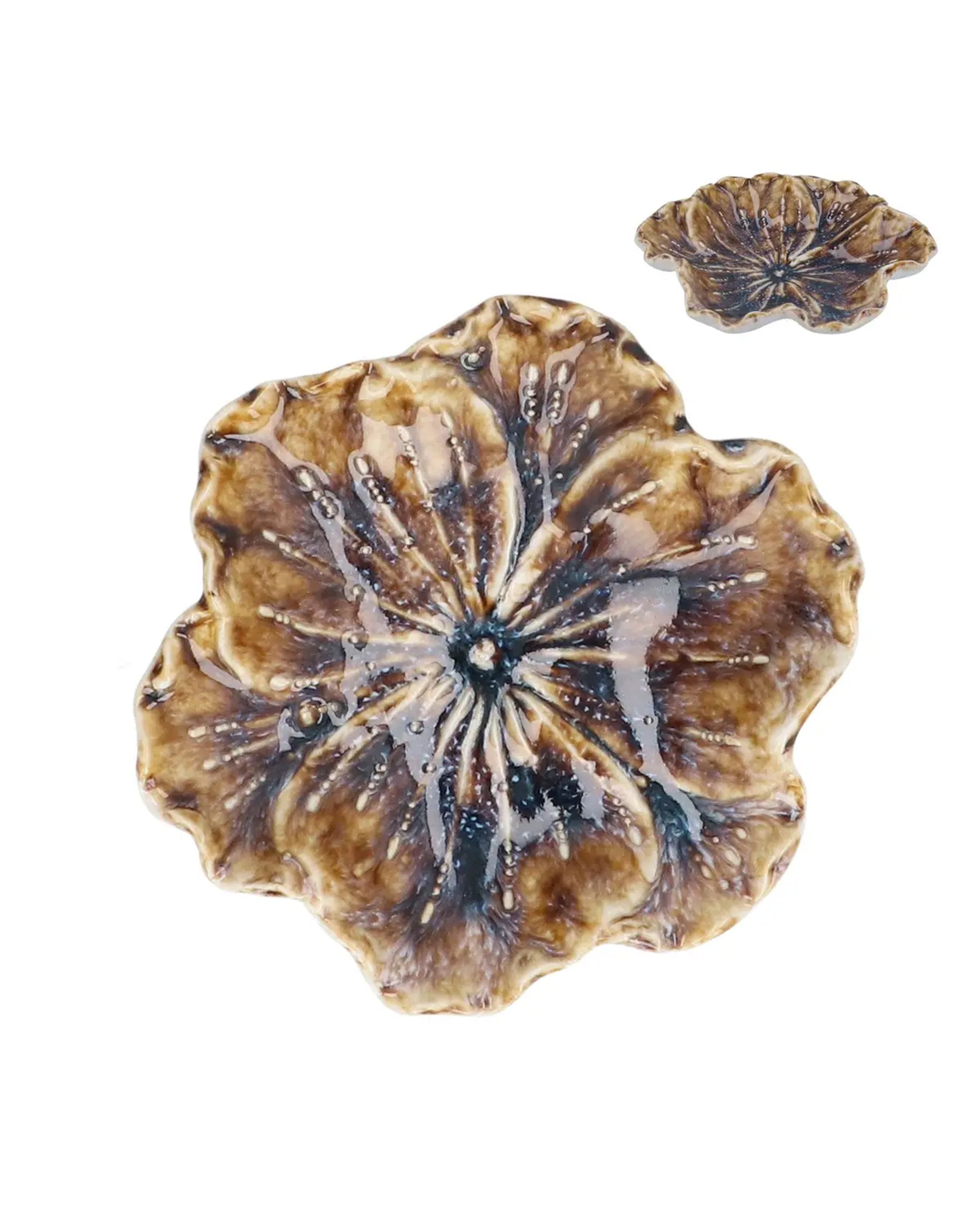 The Faire Nat. Stoneware Hellebore Trinket Dish set includes two flower-shaped ceramic dishes, one large and one small, with a brown and beige glaze—ideal as charming decorative accents for your home.