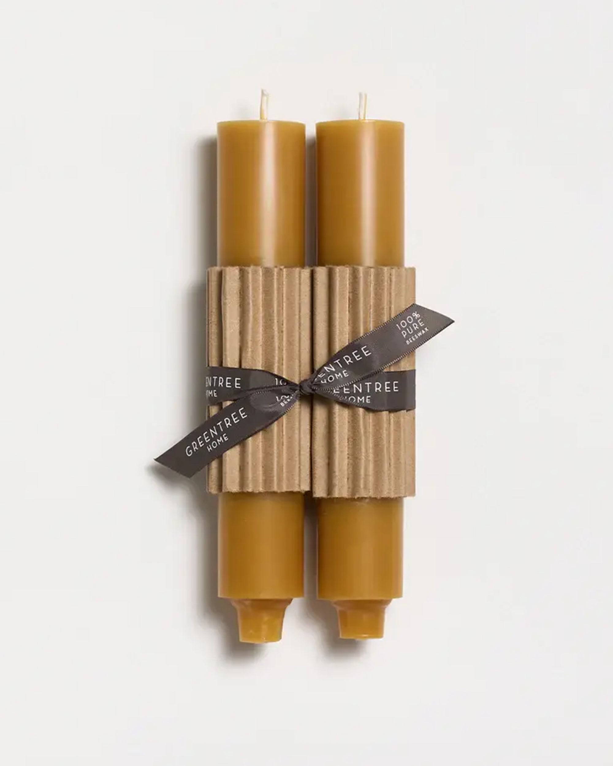 Two 9" Taper Candles by Faire, in a natural color, hand poured and bundled with corrugated cardboard and a black ribbon, displayed on a white background.