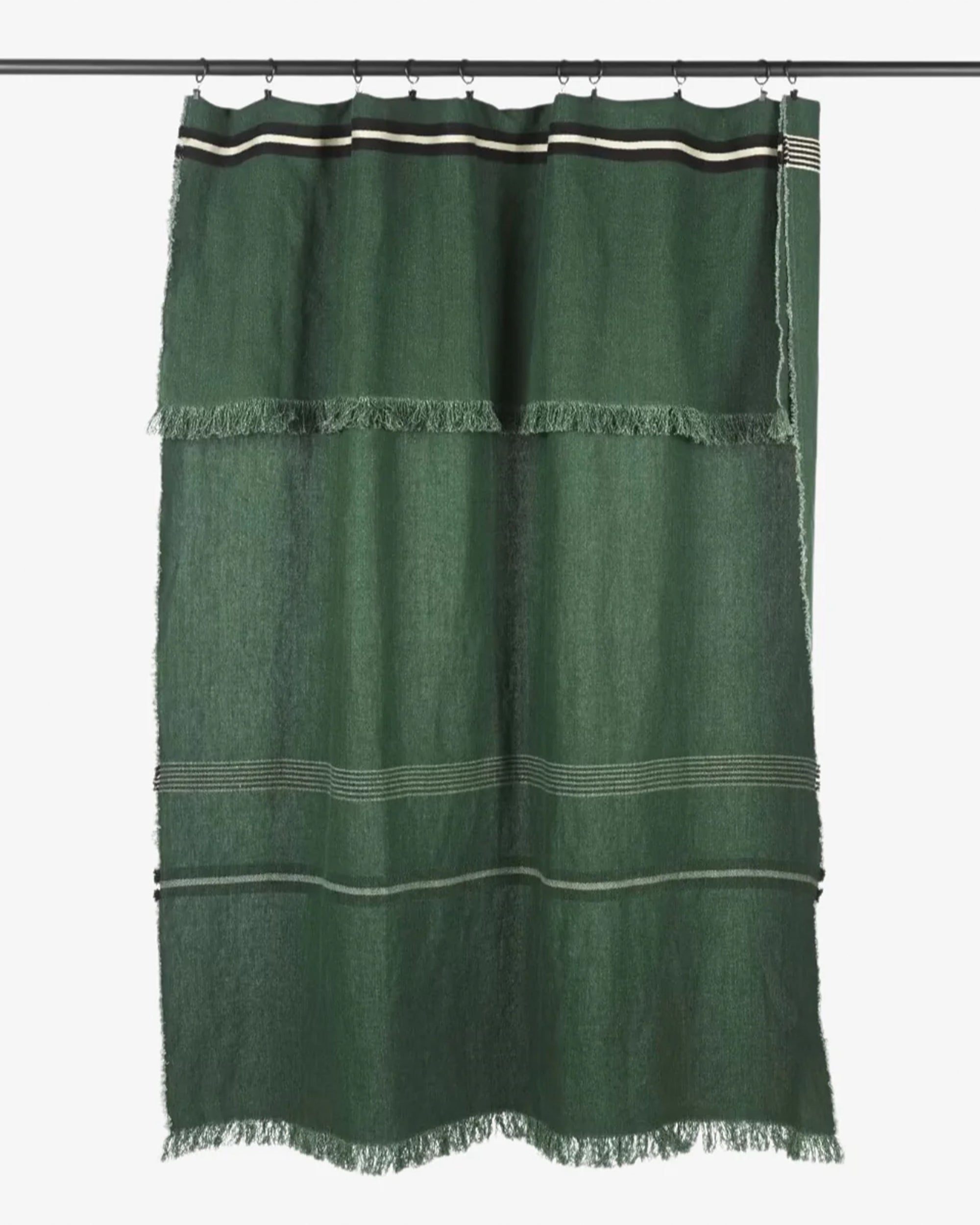Green linen shower curtain with fringe on a black rod, Libeco Home Nell Piece de Lin Stripe collection.