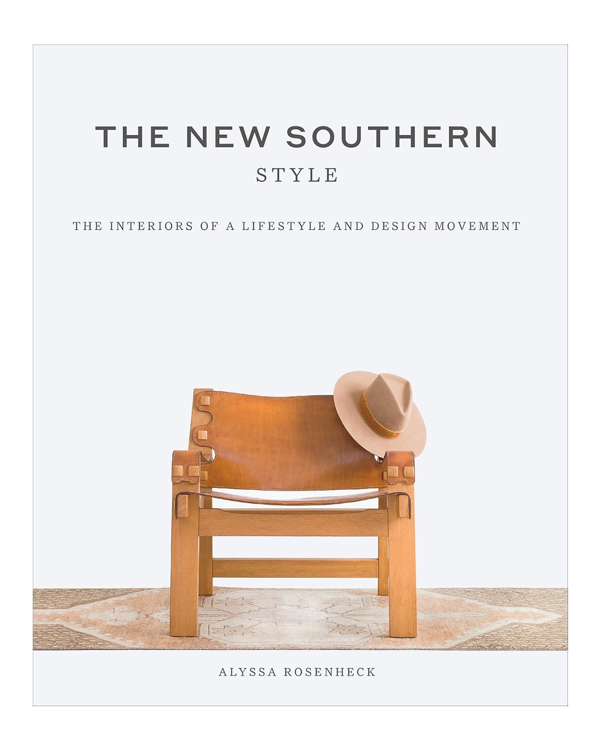 Book cover for "New Southern Style: The Inspiring Interiors" by Hachette Book Group, showing a tan leather chair on a rug with a beige hat on the arm, evoking Southern style against a simple white background.