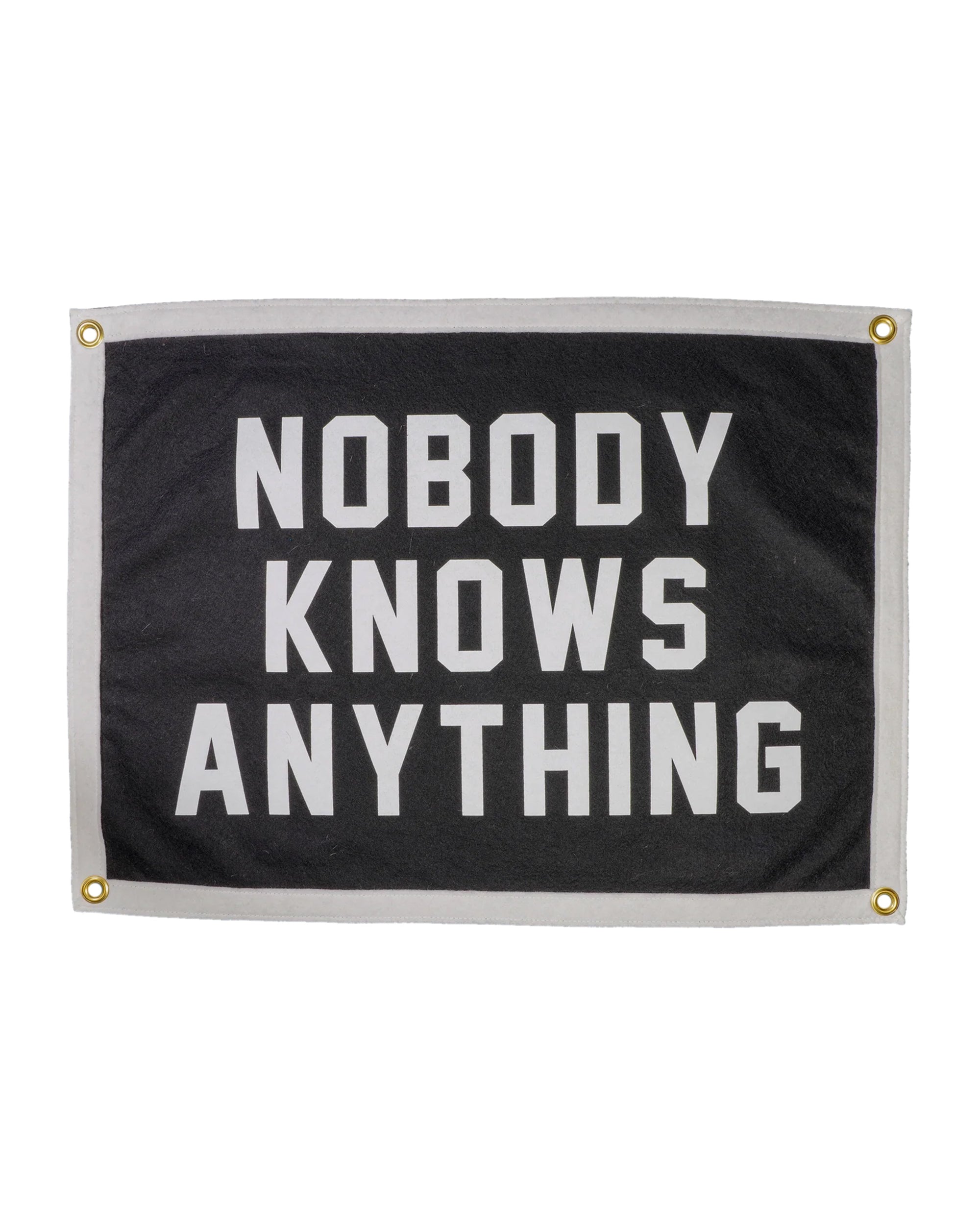 The Oxford Pennant Nobody Knows Anything Camp Flag is a black and white rectangular flag with a white border, corner grommets, and bold text reading "NOBODY KNOWS ANYTHING," perfect for embracing a clueless spirit.