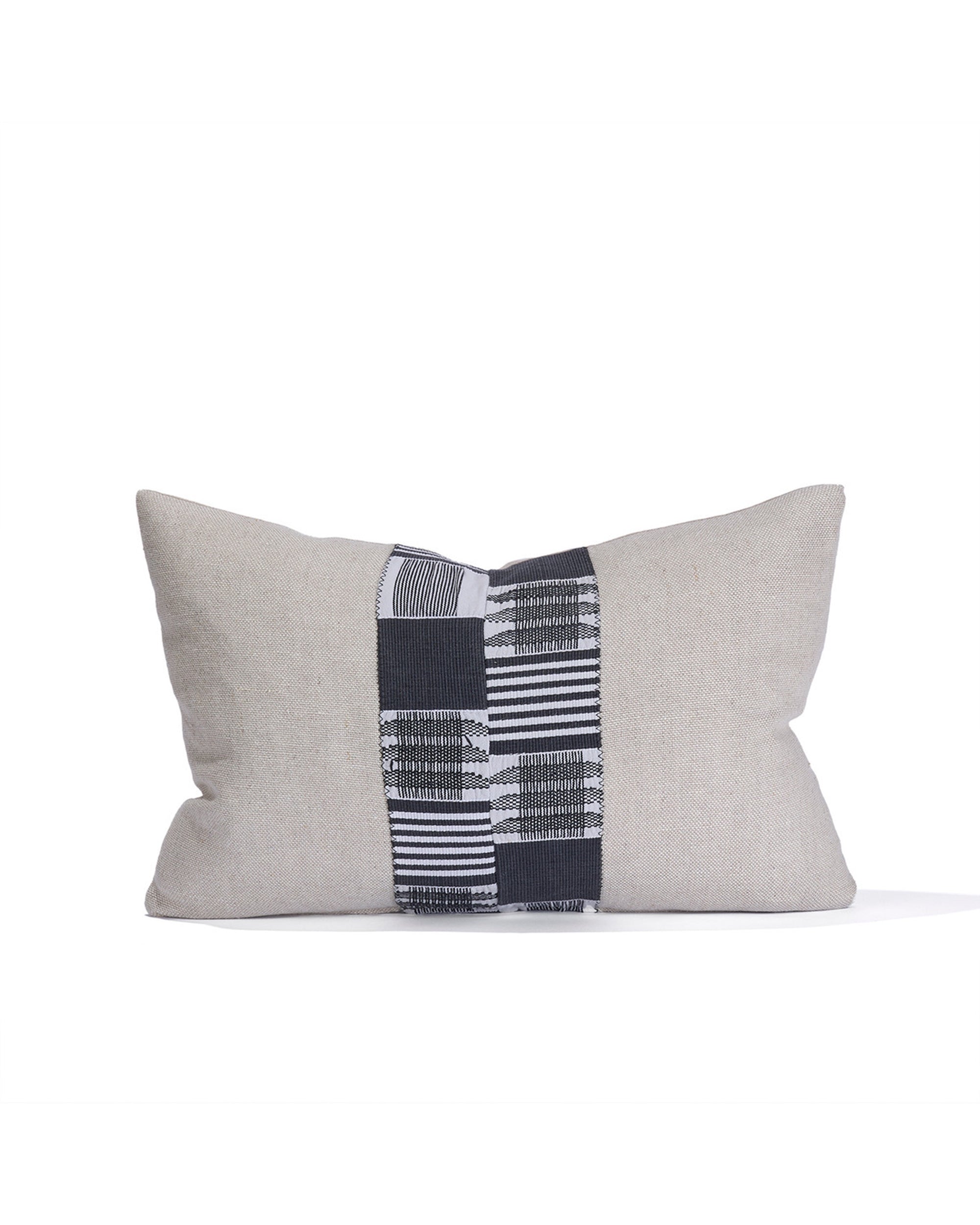 The Pleasing Lumber Pillow Noir by House Of Cindy is a rectangular beige pillow with a central black and white geometric stripe, inspired by vintage textiles and crafted as an eco-friendly accent.