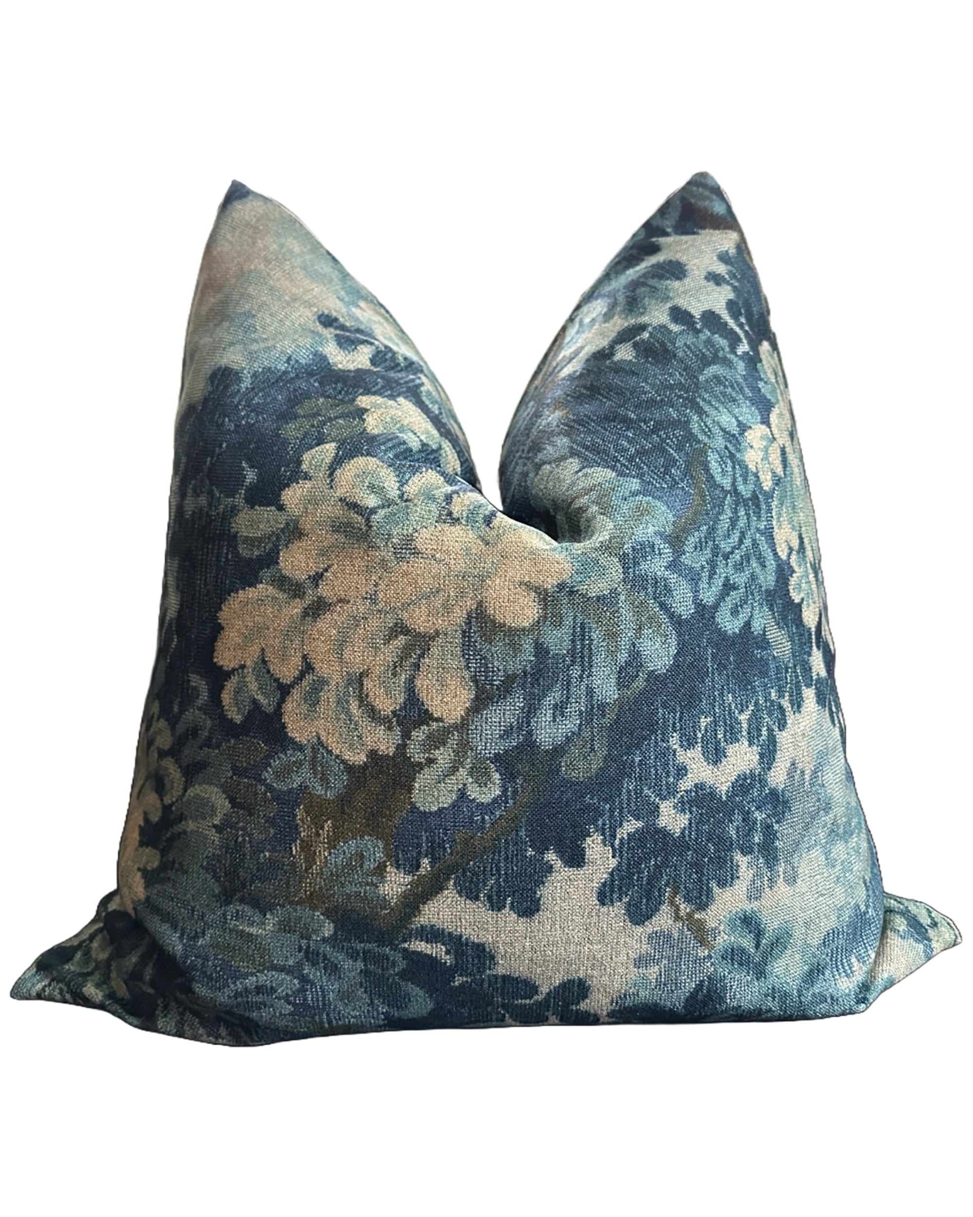 Blue and cream floral Faire Nola pillow with woven, soft-textured cover, pictured on white background.