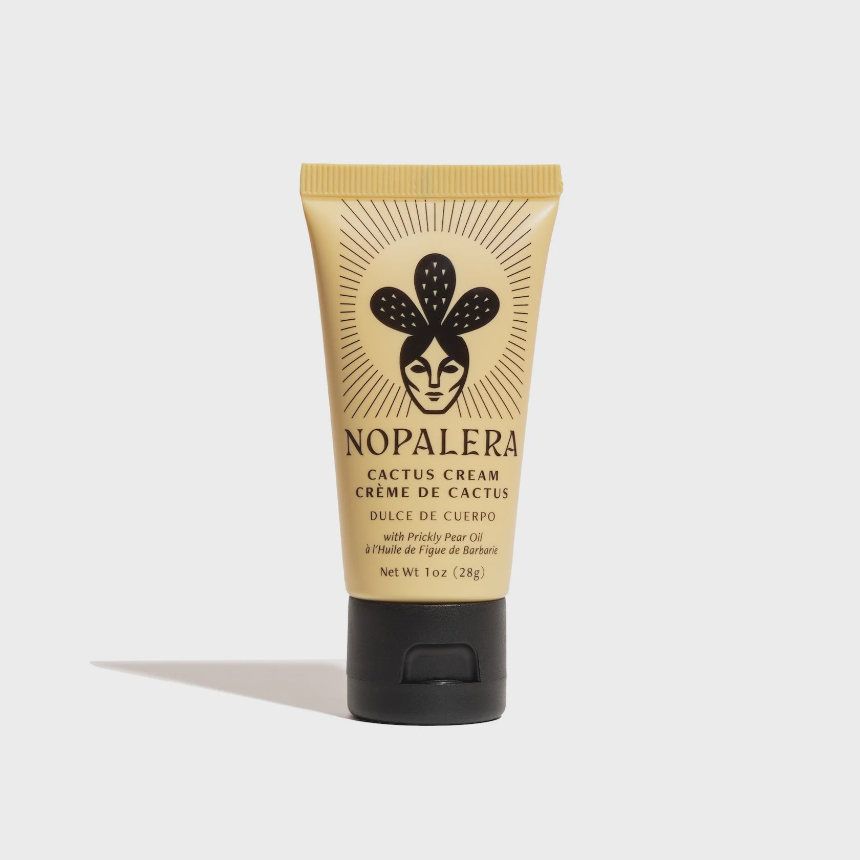 A yellow tube of Faire Mini Cactus Creme with a black flip cap, featuring a stylized face and cactus logo, described as a rich body nourishment cream with prickly pear oil.