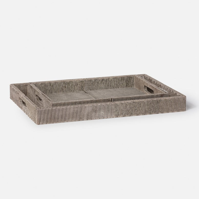 Introducing the Fenmore Tray by Made Goods: a rectangular wooden tray featuring parallel grooves and two cut-out handles on the shorter sides. Its natural, textured finish offers a rustic look, inspired by hair-on-hide textures.