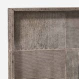 Close-up of the Fenmore Tray by Made Goods, showcasing a textured rectangular surface with a grid-like pattern created by intersecting vertical and horizontal lines. The tray's material is gray, featuring a rough, woven appearance reminiscent of hair-on-hide texture.