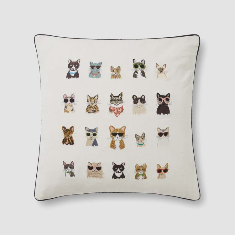 This 100% cotton square pillow, the Ivory 22x22 by Loloi Rugs, features an amusing grid of illustrated cats adorned with different sunglasses and accessories set against a white background. Made in India, each cat portrays its own unique style, enhancing the playful and whimsical design.