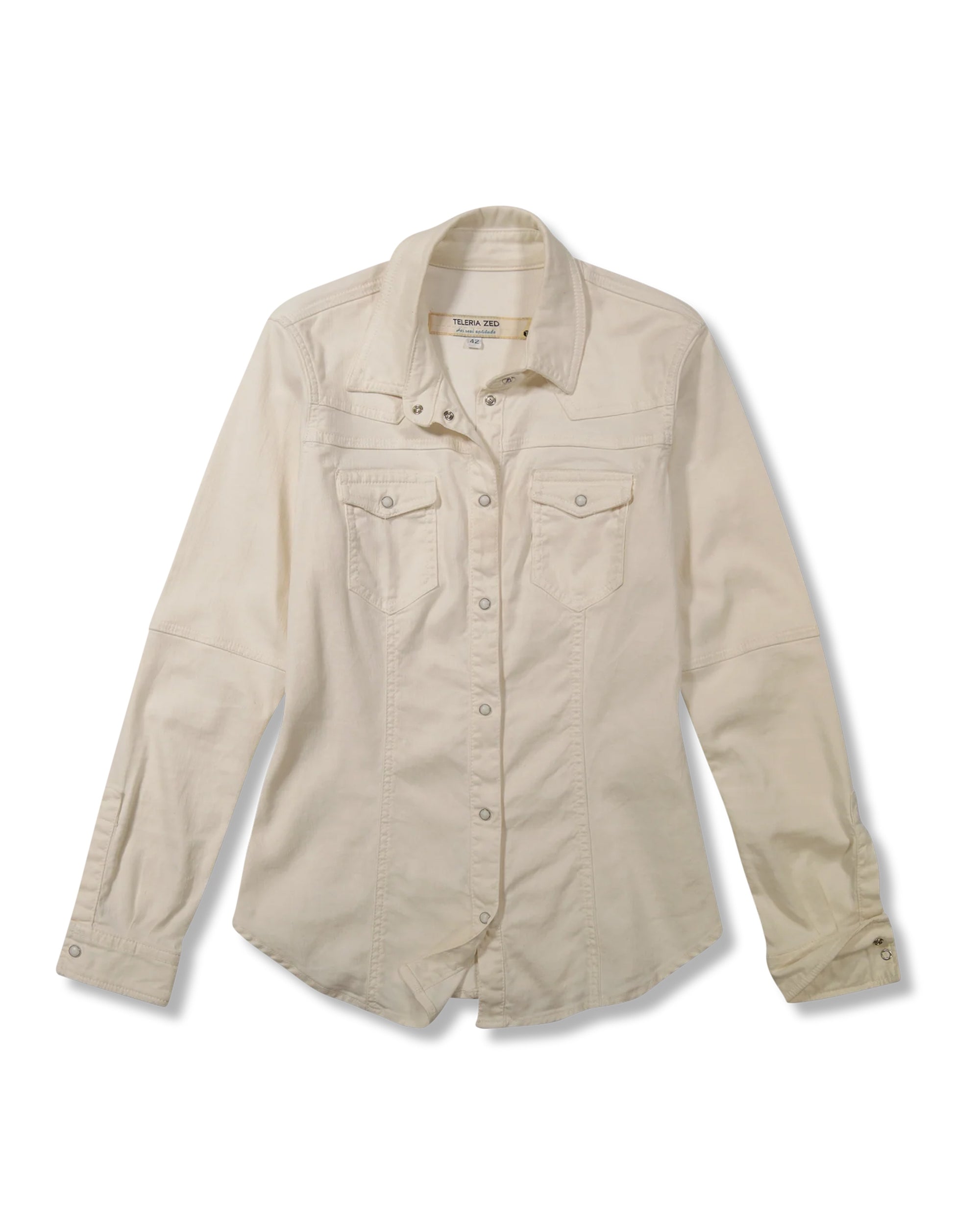 The Teleria Zed Pacifica Shirt is an off-white, long-sleeve button-up with two chest pockets and a collar, shown flat on a white background—perfect for gentle washing and proper storage to keep its crisp look.