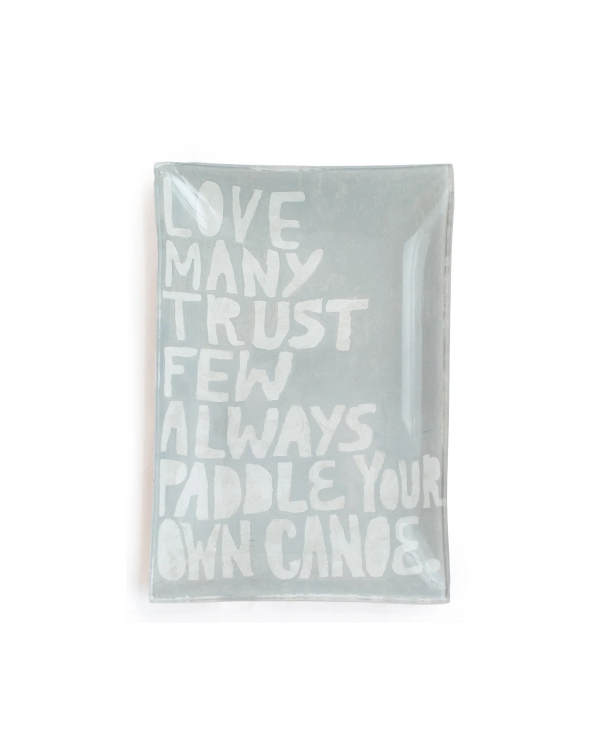 The Sugarboo Designs Paddle Your Own Canoe Rec Plate is a rectangular glass tray with "LOVE MANY TRUST FEW ALWAYS PADDLE YOUR OWN CANOE" in bold white on pale gray, ideal as a jewelry holder or display piece alongside art prints.