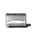 The Faire Paper Towel Wall Case is a silver aluminum tissue dispenser with a matte finish and rectangular design, featuring a slot that reveals a partially pulled tissue, casting a shadow on a white background.