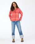 A woman stands against a white background wearing the Kerri Rosenthal Pia Western Flannel, cuffed blue jeans, and brown boots. Her hands are in her pockets and she looks forward with a relaxed expression.