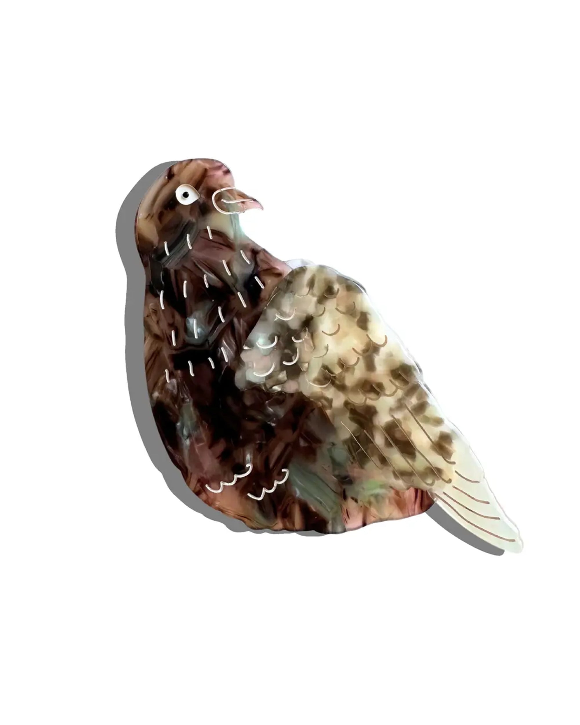 The Faire Hand Painted Pigeon Clip is an eco-friendly cellulose acetate brooch, featuring a simple brown and beige stylized pigeon with a glossy finish and faint gray shadow on a plain white background.