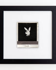 A framed artwork with a black rabbit silhouette on a textured dark background, displayed against a white wall. The rabbit, positioned centrally, features an acrylic and modern design. This art piece is displayed in the Match South Art Square Black Frame.