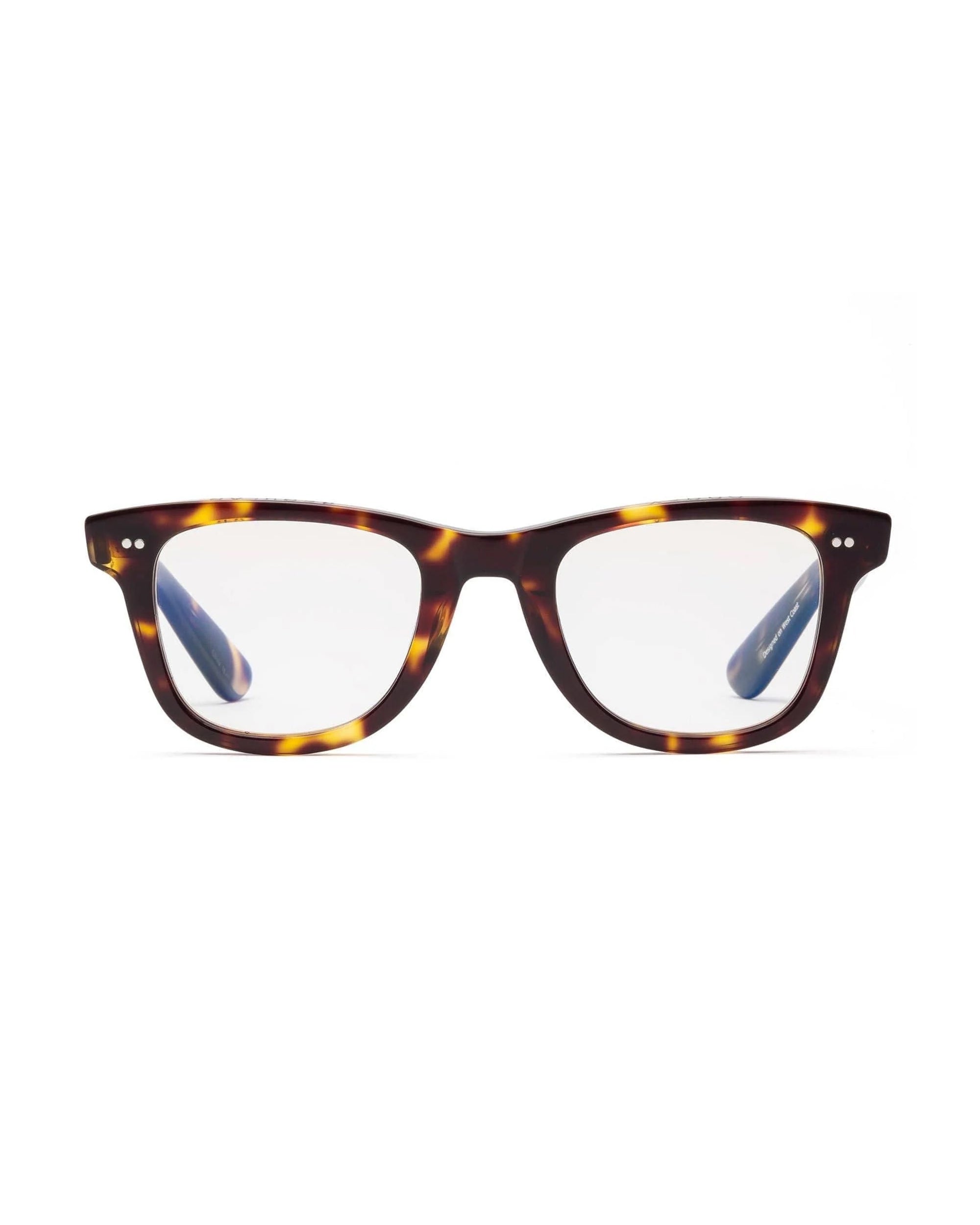 The Caddis Porgy Backstage eyeglasses feature a brown and yellow tortoiseshell rectangular frame in premium acetate, silver temple accents, and clear scratch-resistant lenses, shown from the front against a white background.