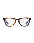 The Caddis Porgy Backstage eyeglasses feature a brown and yellow tortoiseshell rectangular frame in premium acetate, silver temple accents, and clear scratch-resistant lenses, shown from the front against a white background.