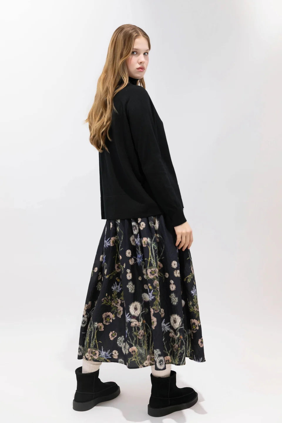 Psophia 2894 black skirt styled with matching top and boots, Bungalow Furniture &amp; Accessories, minimal backdrop.