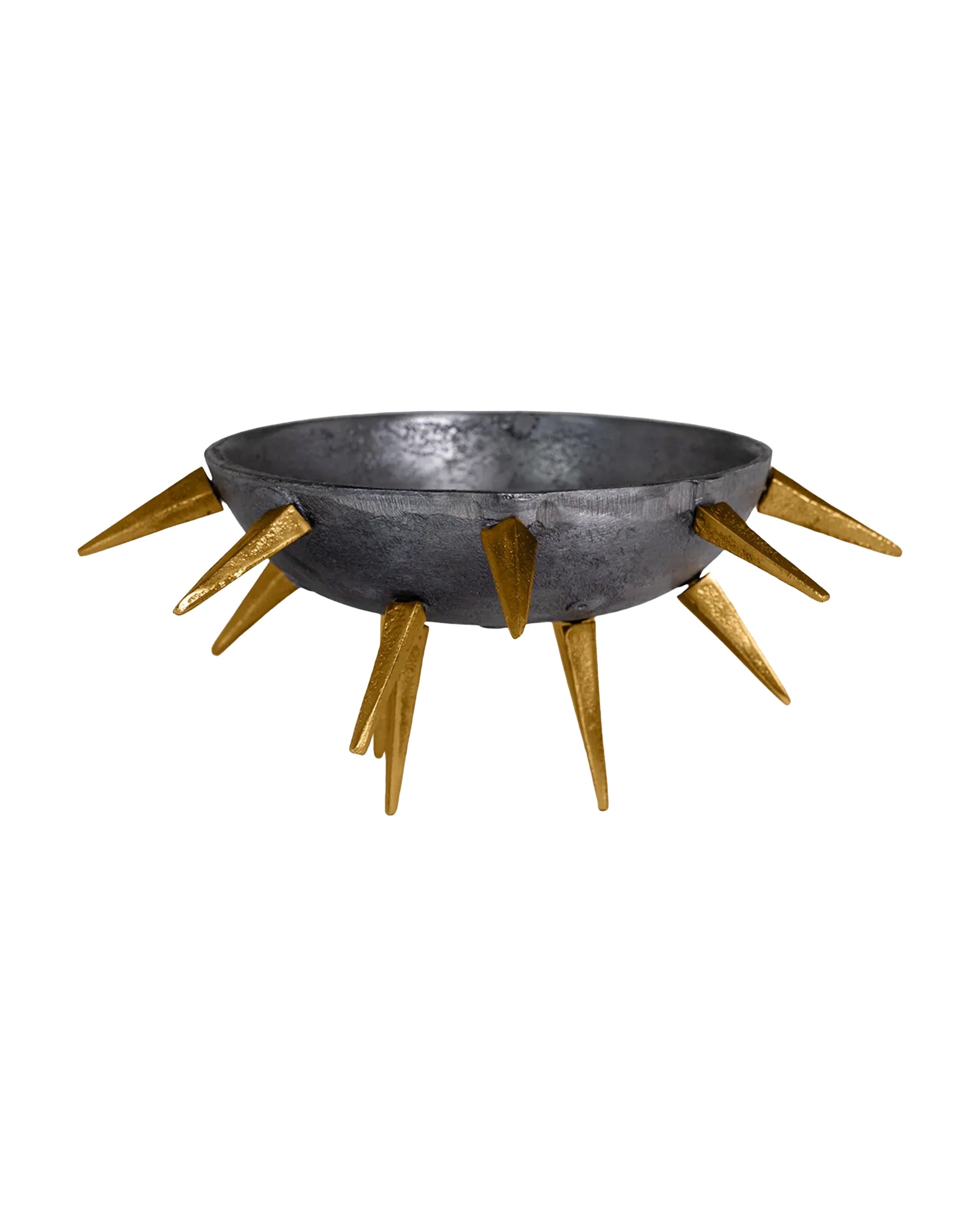 The Import Collection's Punk Centerpiece is a round, metallic aluminum bowl with a dark finish and gold spikes around the rim, creating an industrial chic look. Perfect as a striking decorative accent. White background.