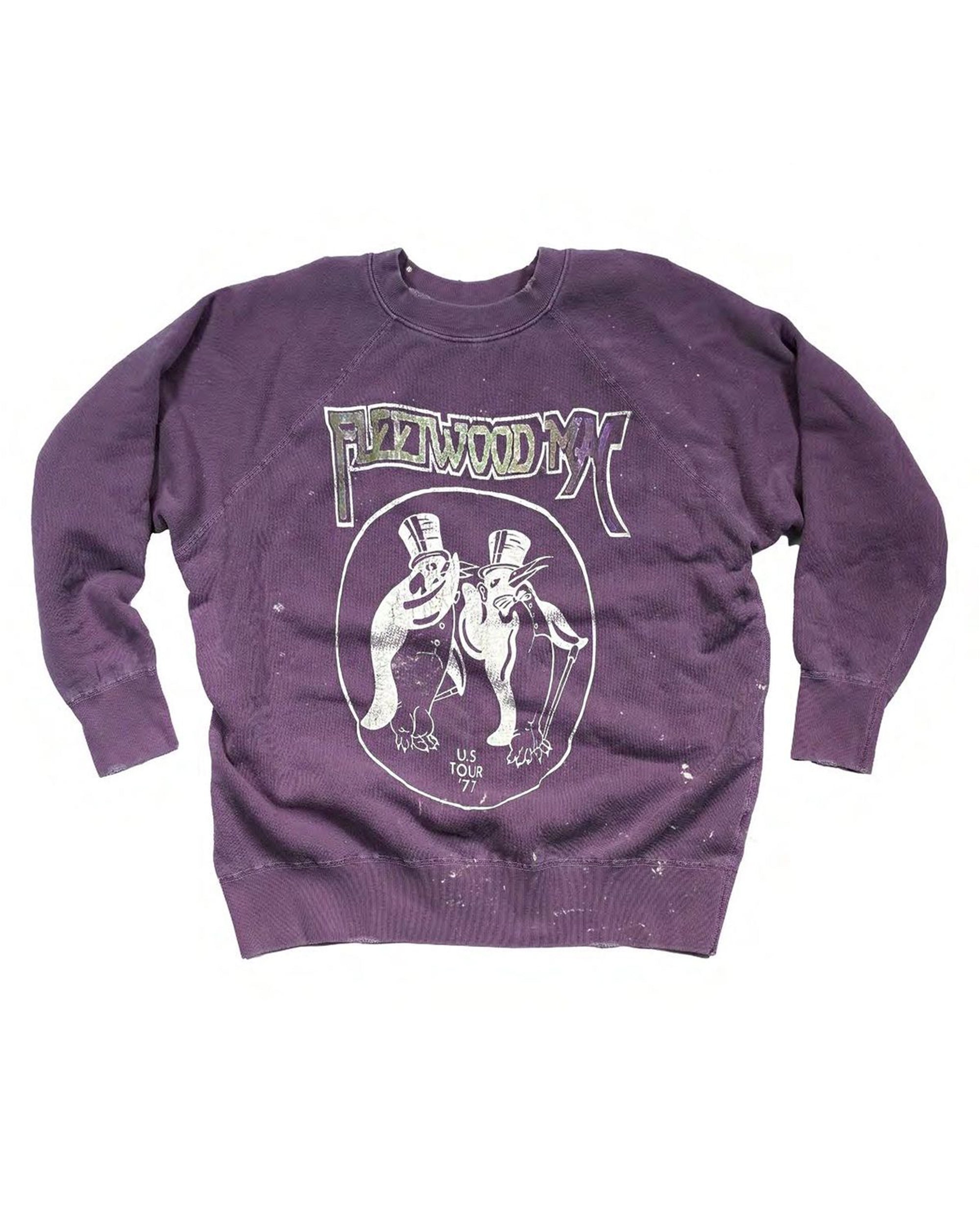 The Fleetwood Mac Shrunken LS Sweat by Made Worn is a purple crew sweatshirt with two cartoon penguins in top hats and bow ties, plus "PENGUINWOOD MX" and "US TOUR" text—a playful pick for any Fleetwood Mac fan.
