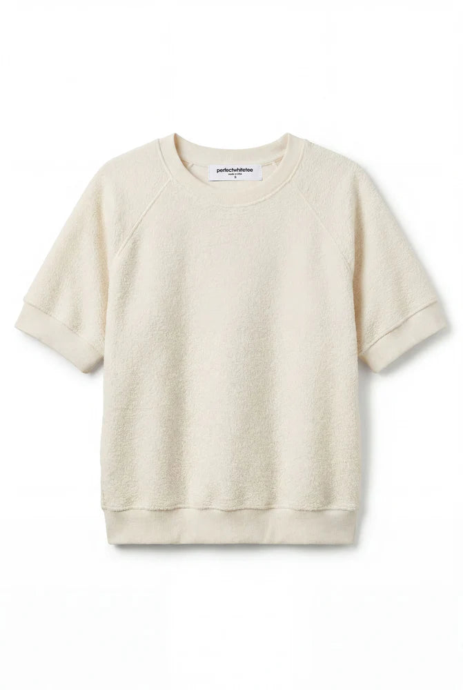 The Kennedy SS Crew Sweatshirt by Perfectwhitetee features a relaxed fit in cream, with short sleeves, crew neckline, and ribbed cuffs and hem, shown against a plain white background.
