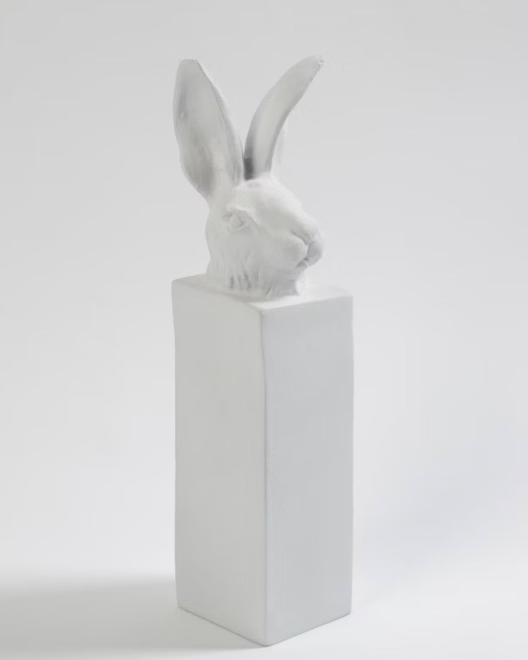 The WDSAC9007 Rabbit Head by Global Views is a white cast aluminum sculpture featuring a rabbit's head with tall ears on a smooth rectangular block, adding unique charm to home decor.