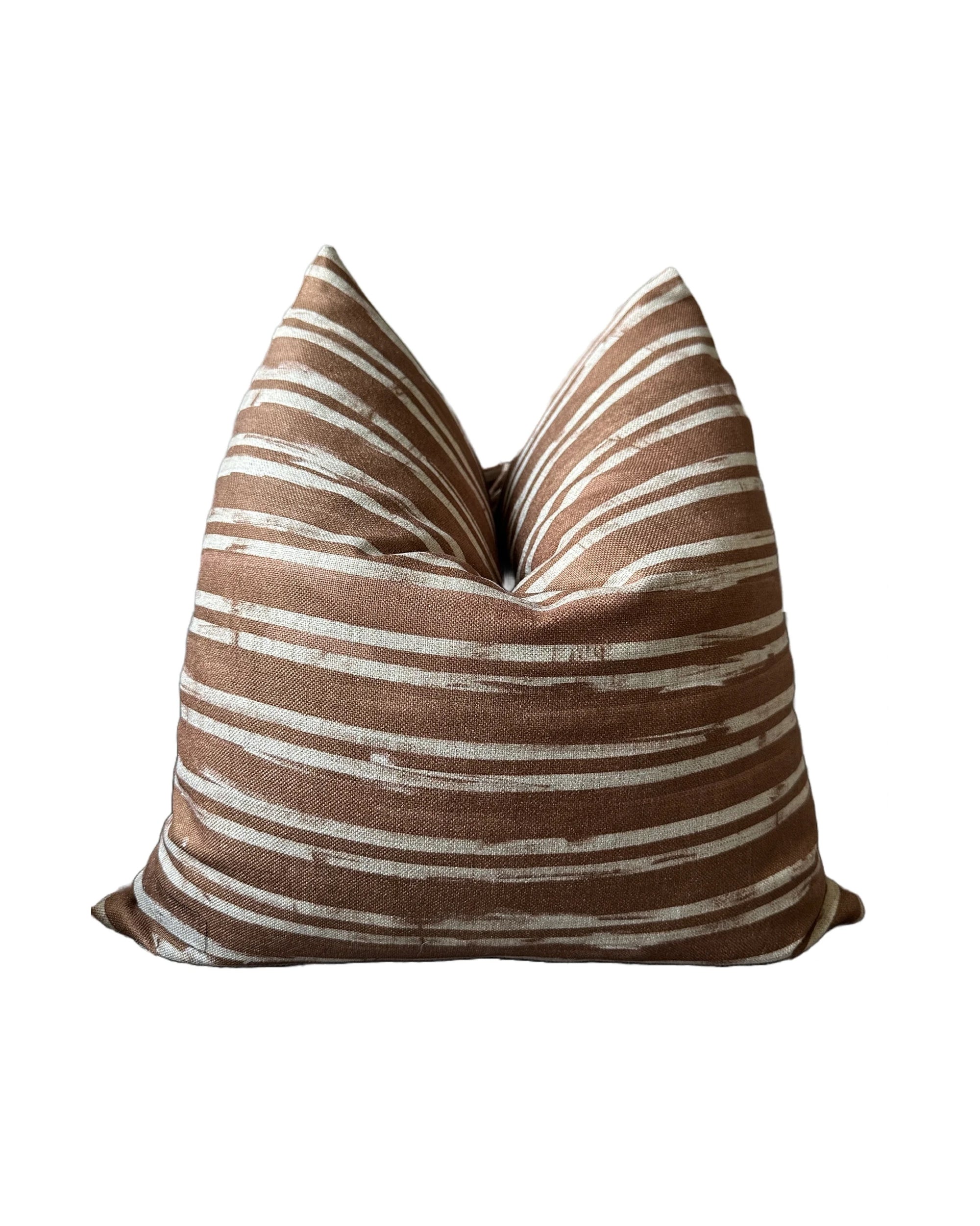 The Radcliff Pillow 22x22 by Rennah Collective features a brown and white horizontal striped pattern on a soft polyester-linen blend cover, with gentle center creasing, displayed against a plain white background.