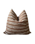The Radcliff Pillow 22x22 by Rennah Collective features a brown and white horizontal striped pattern on a soft polyester-linen blend cover, with gentle center creasing, displayed against a plain white background.