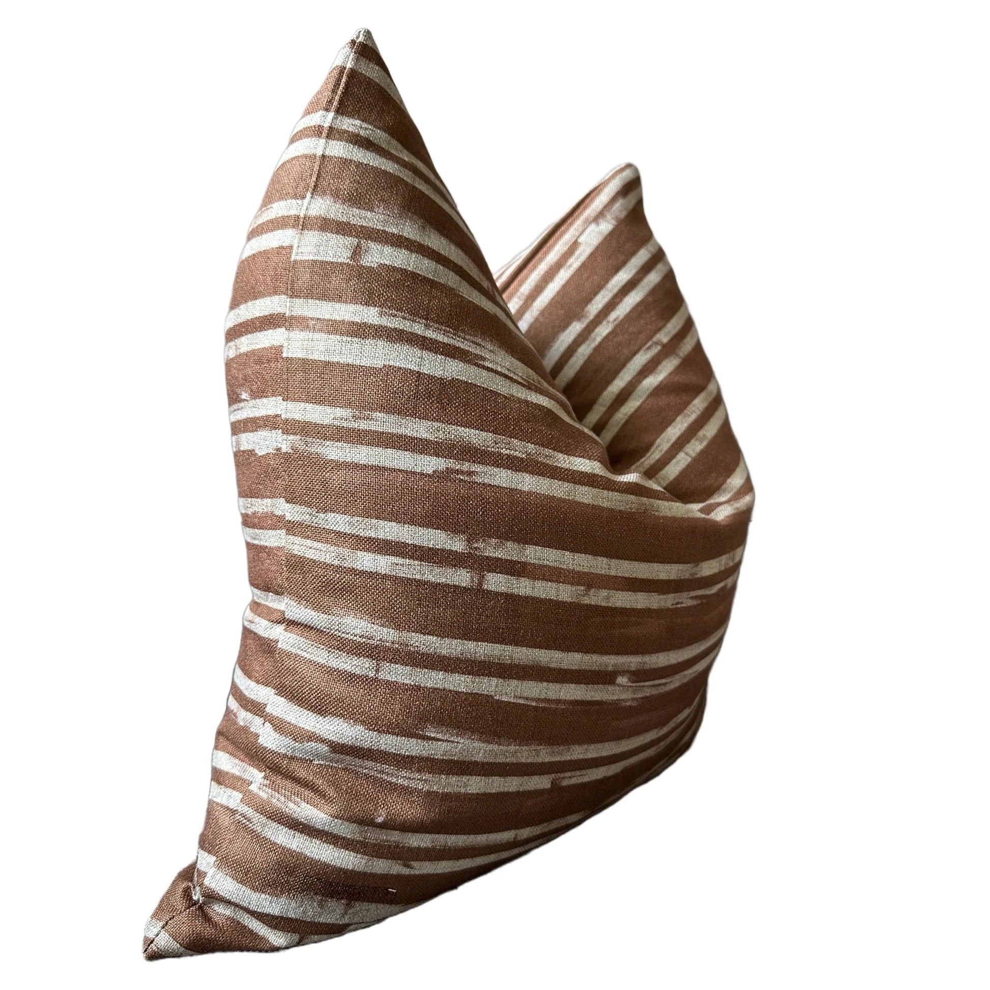 The Rennah Collective Radcliff Pillow 22x22 features a brown woven cover with white horizontal stripes, shown from an angled side view on a white background, bringing stylish flair to any space.