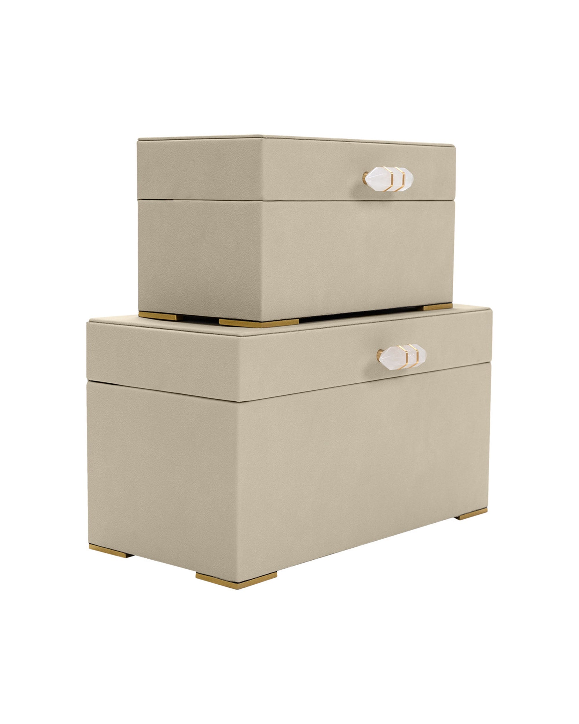 Two Ramato Boxes by The Import Collection—beige fabric storage boxes with gold-tone handles and feet—stacked together against a white background, ideal for adding stylish, modern decor to your home.