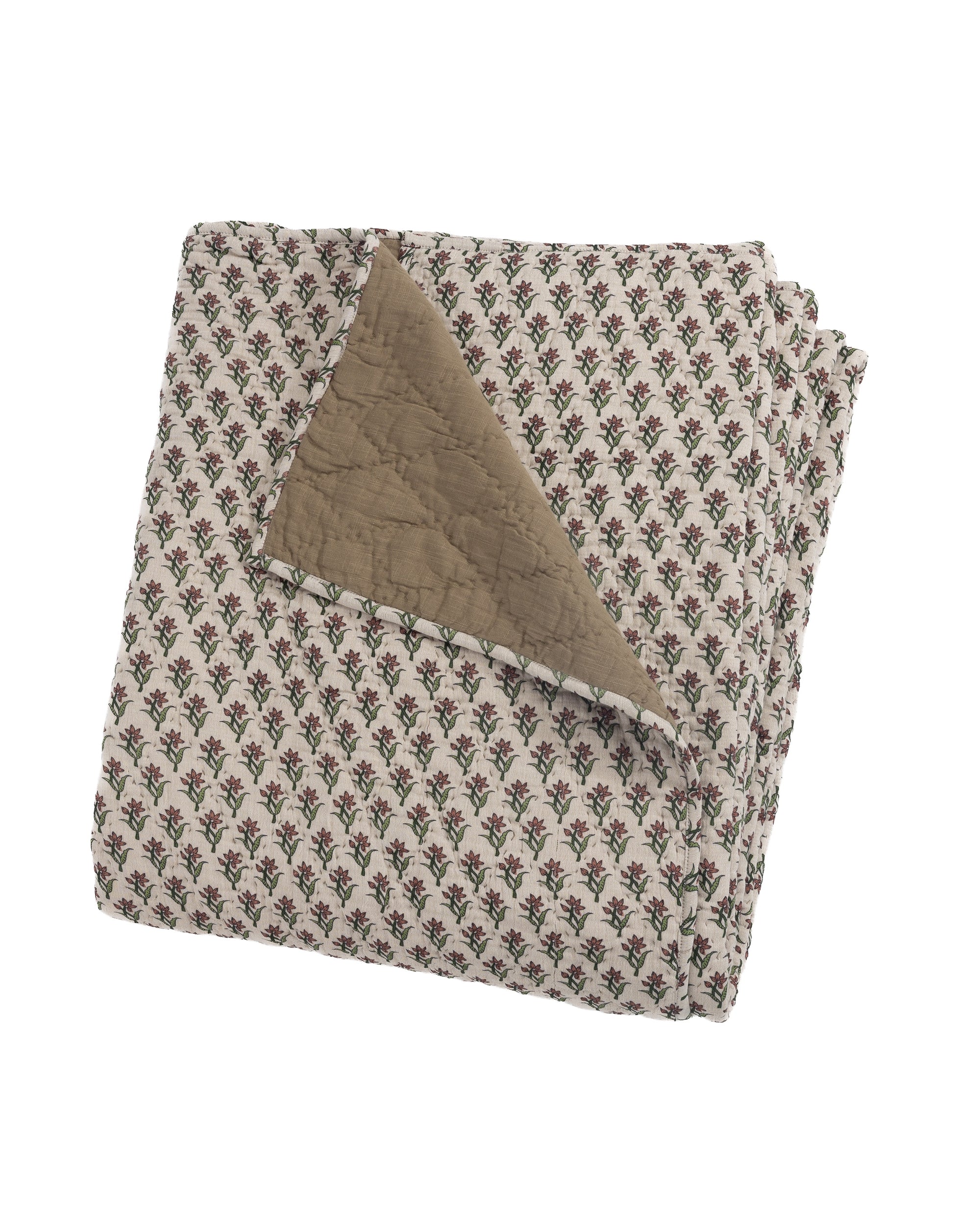 Folded floral cotton quilt with tan reverse by Amity Home, RANI style, shown on a white background.