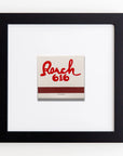 A square ceramic tile with "Roach 616" handwritten in red, framed in a Match South Art Square Black Frame against a white background.